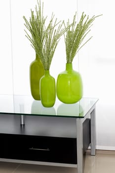 Dried leaves in vases on a table