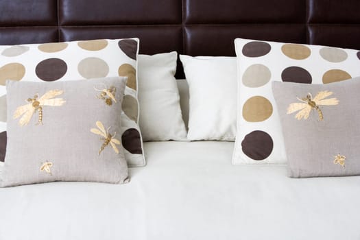 Close-up of cushions and pillows on the bed