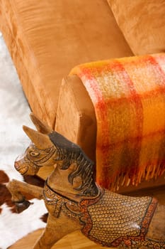High angle view of a wooden horse near a couch