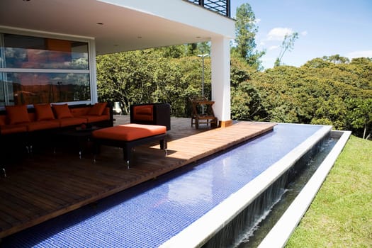 Couch and an armchair in a patio of a house