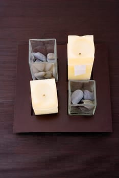 High angle view of candles and pebbles on a table