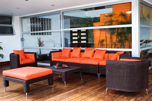 Couch and armchairs in a patio of a house