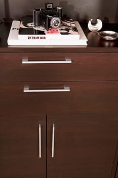 Camera and books on a cabinet