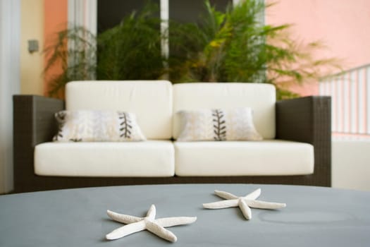 Toy star fish on a table with a couch in the background