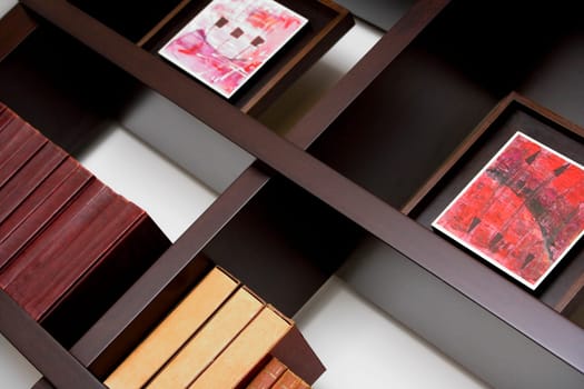 Close-up of books and picture frames in shelves