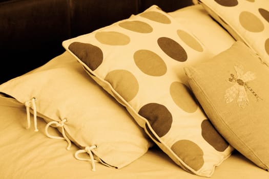 Close_up of pillows and cushions on the bed