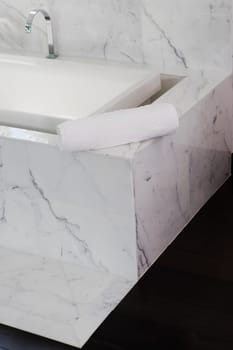 Towel on the ledge of a bathtub