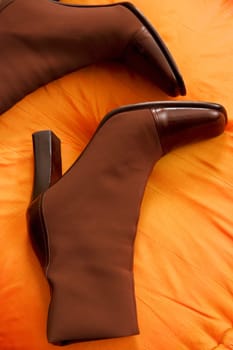 Close_up of a pair of boots on a cushion