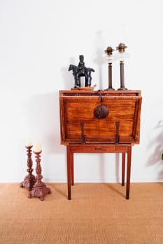 Figurine and lanterns on a chest with candlestick holders