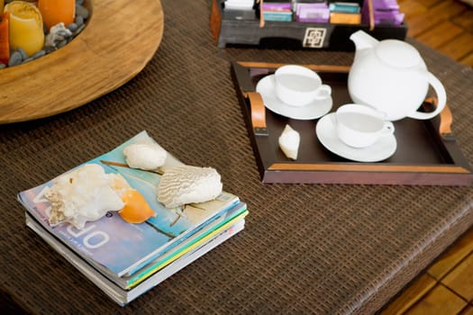 High angle view of a serving tray and magazines on a table