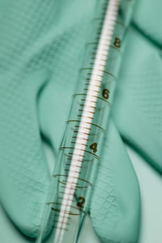 Close_up of a syringe on a glove