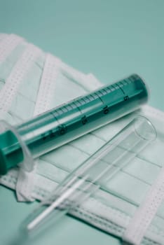 Close_up of a syringe and a test tube