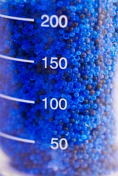 Close-up of granules in a measuring beaker