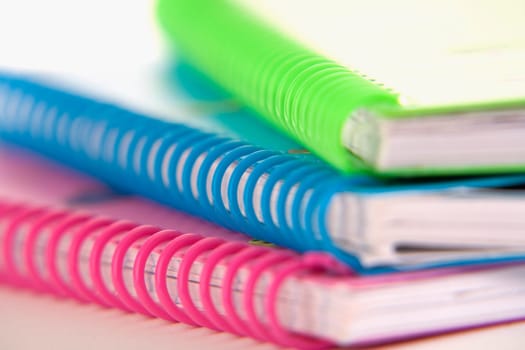 Close-up of three spiral notebooks