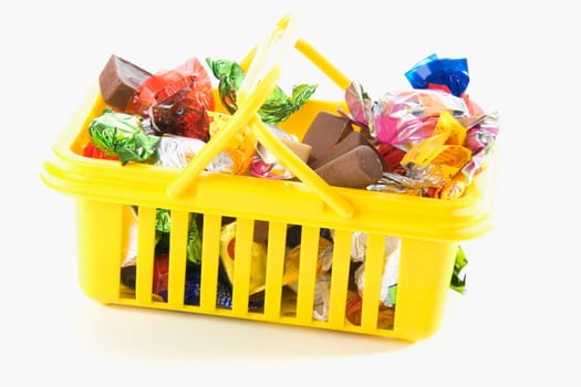 Close-up of chocolates and gifts in a basket