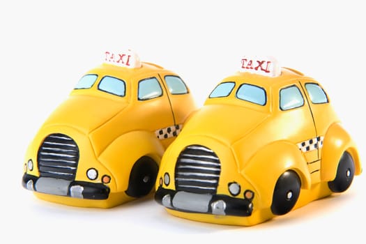 Close-up of two toy taxis parked side by side