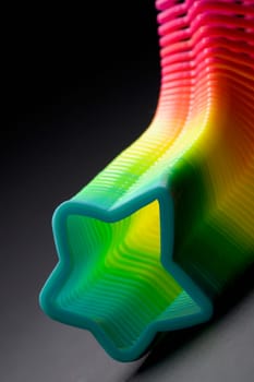 Close-up of a multi-colored star shaped plastic spring
