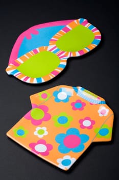 High angle view of a t-shirt and eyeglasses cutout