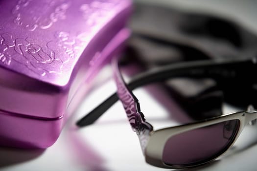 Close-up of a pair of sunglasses with a box