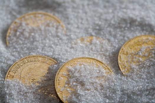 High angle view of five coins in salt