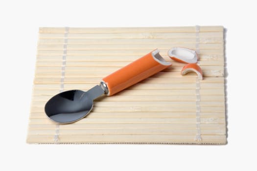 High angle view of a broken spoon on a mat