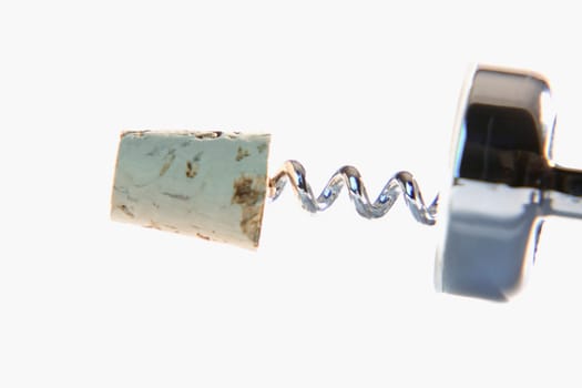 Close-up of a corkscrew with a cork