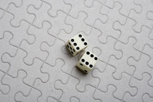 High angle view of a pair of dice on a jigsaw puzzle