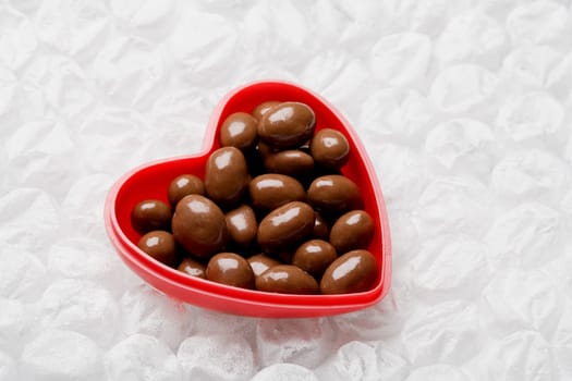 Close-up of chocolates in a heart shaped container