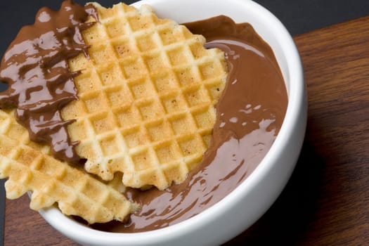 Close-up of a piece of waffle in chocolate