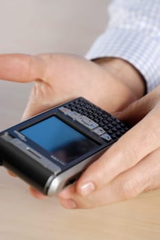 Close-up of a personŽs hand holding a personal data assistant