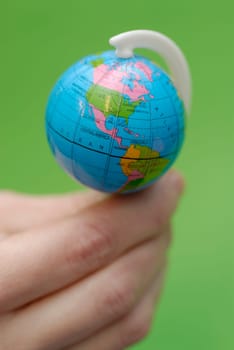 Close-up of a personŽs hand balancing a globe