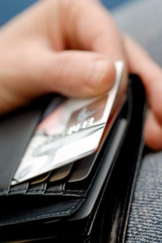 Close-up of a personŽs hand taking a credit card out of a wallet