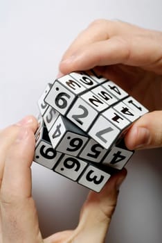 Close-up of a personŽs hands playing with a puzzle cube