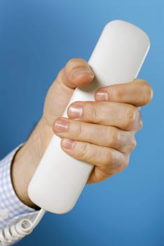 Close-up of a personŽs hand holding a telephone receiver
