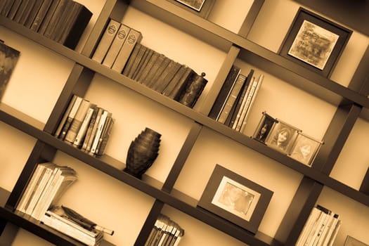 Books and picture frames in shelves