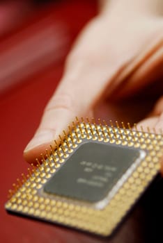 Close-up of a personŽs hand holding a computer chip