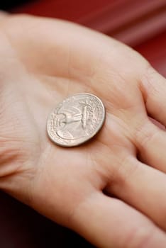 Close-up of an American dollar coin on a personŽs hand