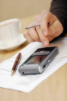 Close-up of a personŽs hand operating a personal data assistant