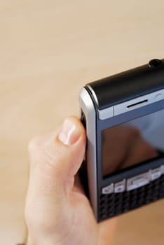 Close-up of a personŽs hand holding a personal data assistant