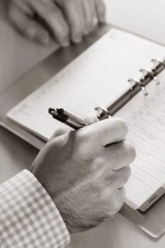 Close-up of a personŽs hand writing in a diary