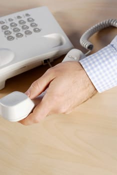 Close-up of a personŽs hand holding a telephone receiver