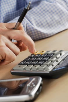 Close-up of a personŽs hand using a calculator