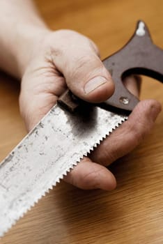 Close-up of a personŽs hand holding a saw