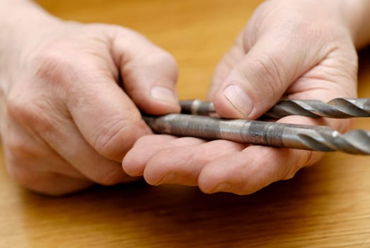 Close-up of a personŽs hand holding drill bits