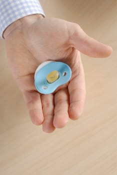 Close-up of a personŽs hand holding a pacifier