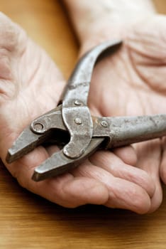 Close-up of a pair of pliers on a personŽs palm