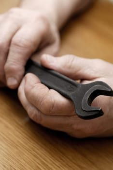 Close-up of a personŽs hand holding a spanner