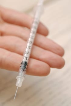 Close-up of a syringe on a personŽs hand