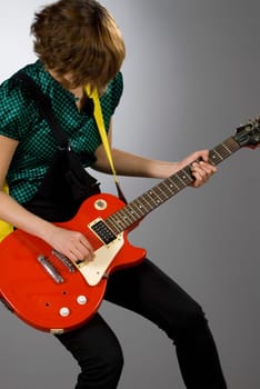 Close-up of a female guitarist playing a guitar
