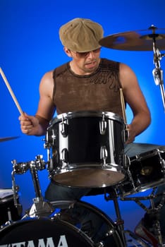 Male drummer playing drums